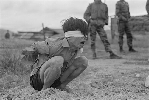 Viet Cong prisoner in stress position.