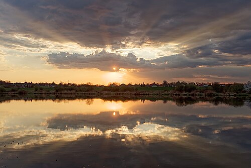 Crepuscular rays at sunset over the Vistula River in Kraków